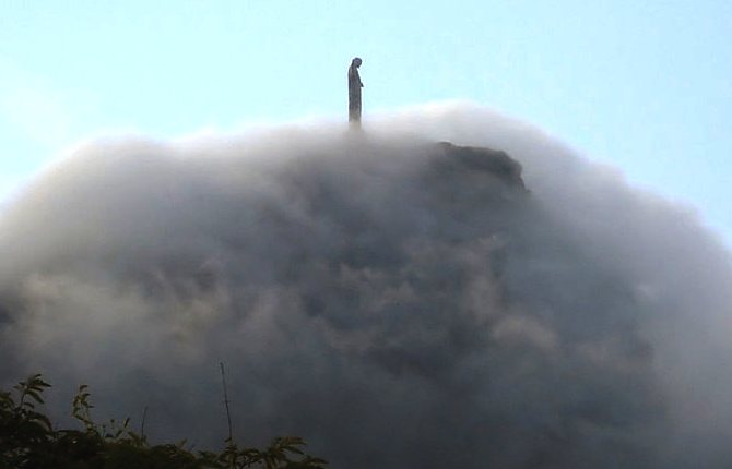 Walking on water, clouds stream across the redeemer statue