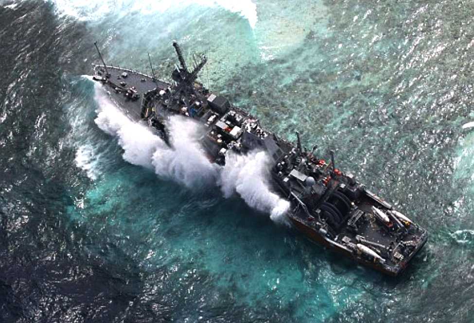 Tubattaha Reef, Philippines - USS Guardian is stuck fast and battered by waves