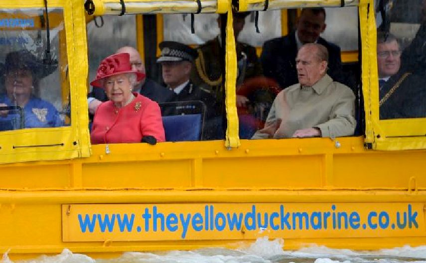 Queen Elizabeth and Prince Philip take a ride in a DUKW