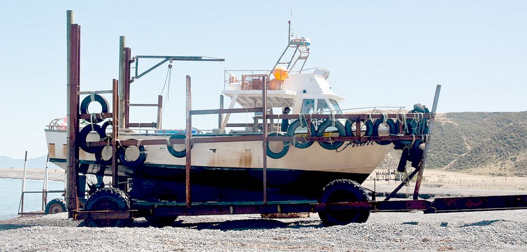 Fishing boat parked on the beach at Ngawi near Wairarapa in New Zealand