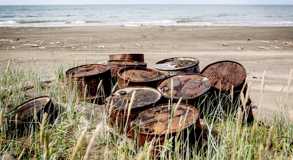 Rusting oil barrels on the shores of the Chukchi Sea