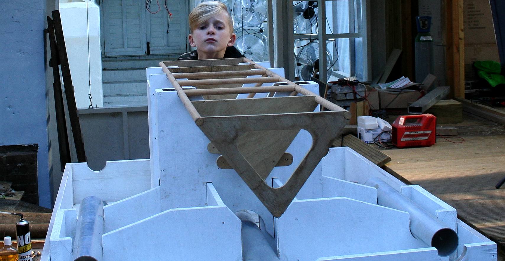 Ryan Dusart inspects a wooden test frame for the Elizabeth Swann